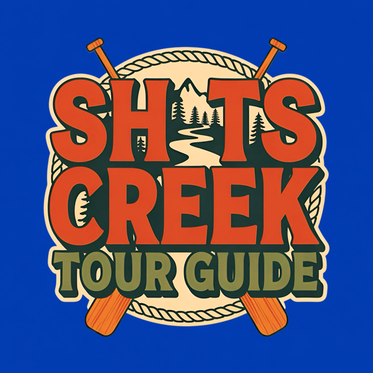 Shits Creek Tour Guide graphic T-shirt featuring bold retro lettering with crossed paddles, rope, mountains, pine trees and a winding creek - royal blue